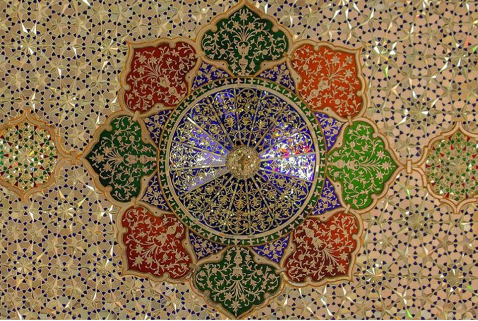 Layered geometric mirrorwork and coloured glass on the ceiling of Zinat al-Molk House in Shiraz